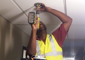 man drilling a ceiling contraption