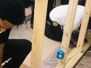 A man is bending over in the middle of building work.
